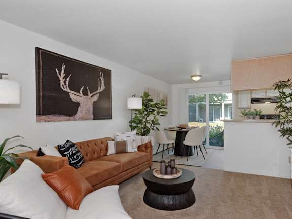Model apartment living and dining room at Crown Court Apartments in Clackamas, Oregon