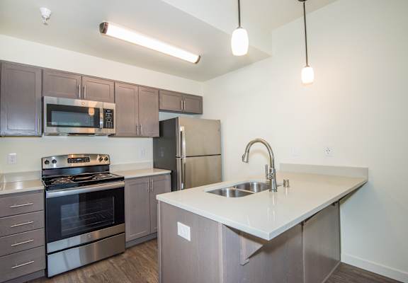 a kitchen with stainless steel appliances and a white counter top