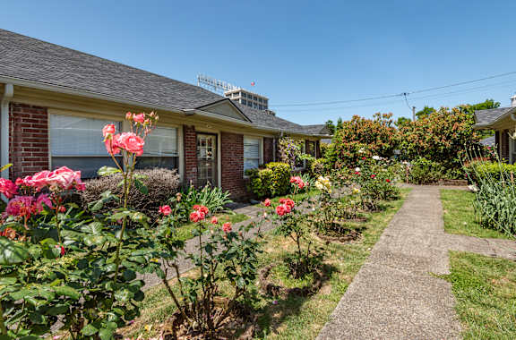 A house with a garden in front of it.