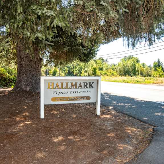 a sign in front of a tree