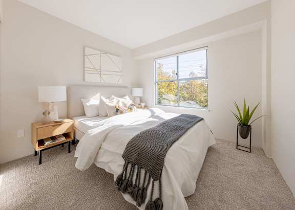 a bedroom with a large bed and a window