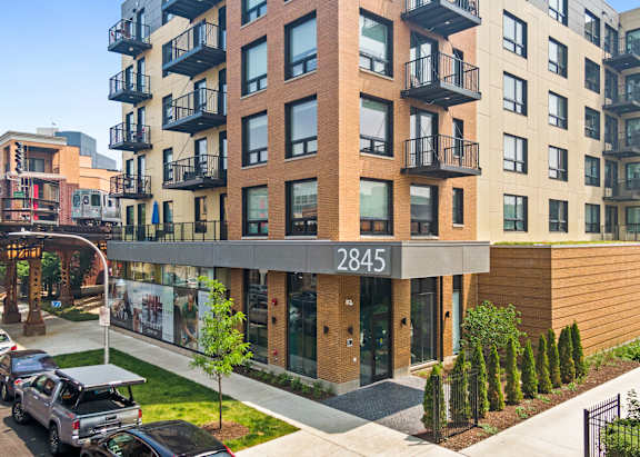 A modern apartment building with the number 2845 on the front.