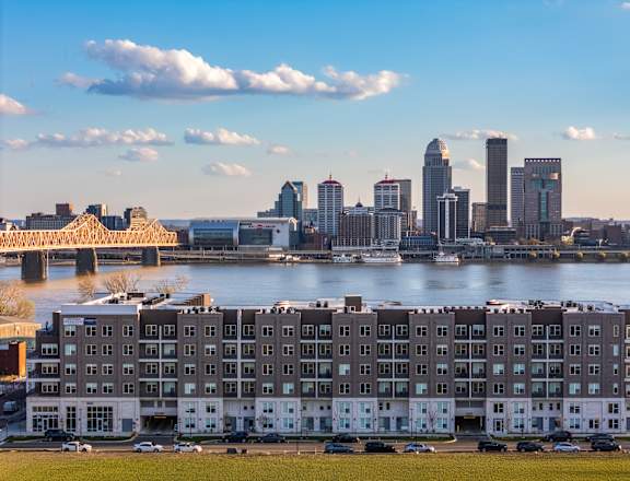 A city skyline is visible in the distance behind a large building.
