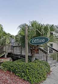 A sign that says Office is in front of a house.