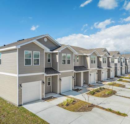 a row of houses in a row on a sidewalk