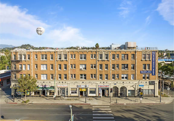 A street view of a building with a blue sign that says "The Standard".