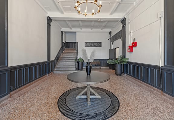 A large open space with a staircase and a chandelier.