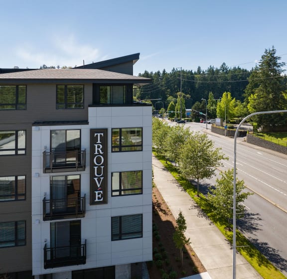 an aerial view of a building next to an empty street