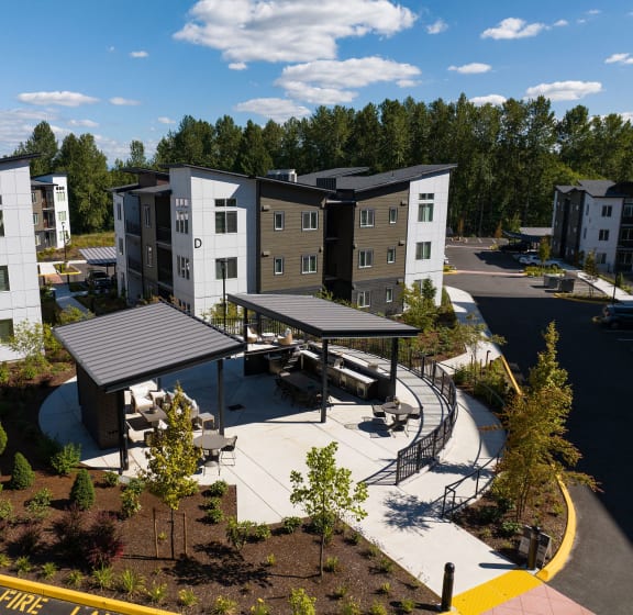 an aerial view of an apartment complex with a parking lot