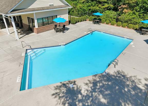 A swimming pool with a building in the background.