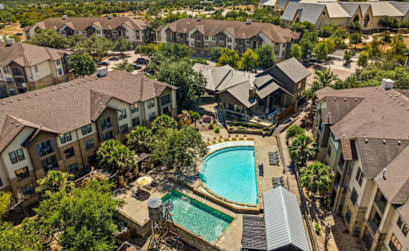 A large swimming pool surrounded by houses.