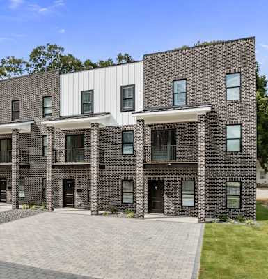 A modern building with a combination of brick and white panels.