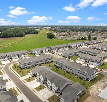 A suburban neighborhood with houses and a road.