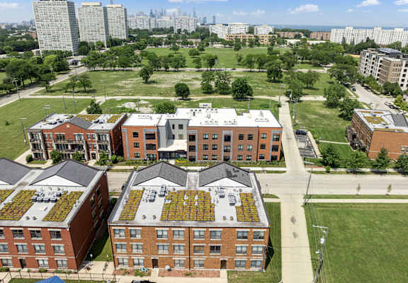 an aerial view of a building with plants on the roof