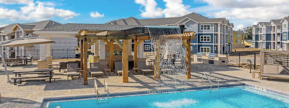 A swimming pool in a sunny outdoor setting.