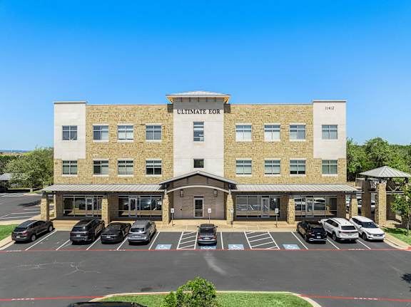 The Ultimate Eor building has a parking lot in front.