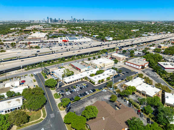 A cityscape with a highway and buildings.