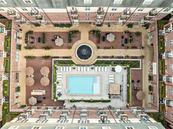 An aerial view of a courtyard with a pool and a fountain.