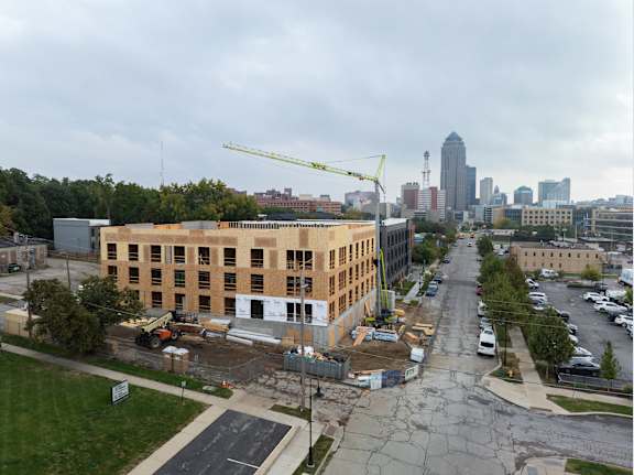 A construction site with a crane and a building under construction.