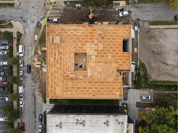 A building under construction with a brown roof.