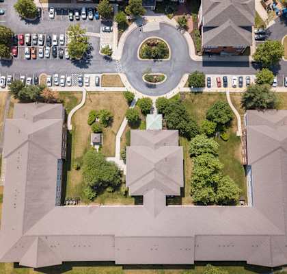 arial view of a campus with cars parked on the street