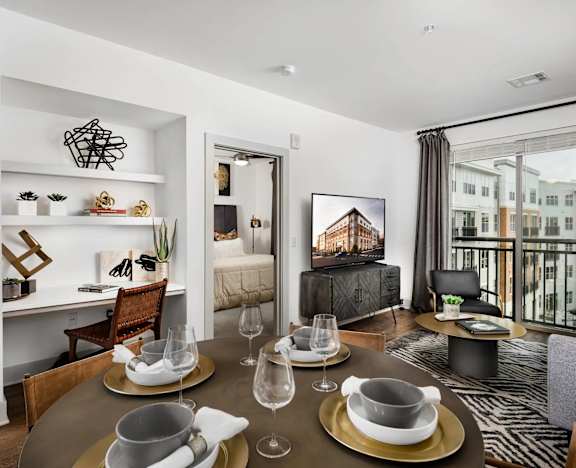 A modern dining room with a glass table set for two.