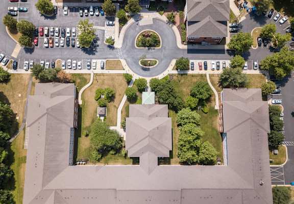 arial view of a campus with cars parked on the street