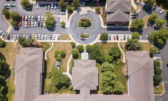 arial view of a campus with cars parked on the street