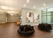 Thumbnail 1 of 8 - a large room with couches and paintings on the wall