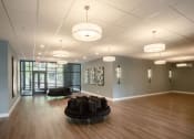 Thumbnail 8 of 8 - a large room with a couch and chairs in the center of it