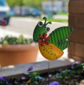 a butterfly with a sign that says welcome