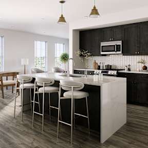 a kitchen with a large island with bar stools and a dining room with chairs