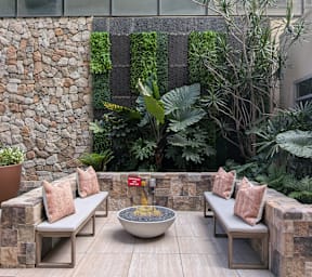 A long bench with a planter on top of it.