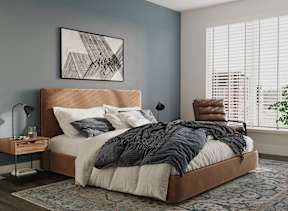 a bedroom with a bed and a chair and a rug