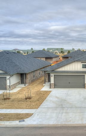a home with two garage doors and a concrete driveway