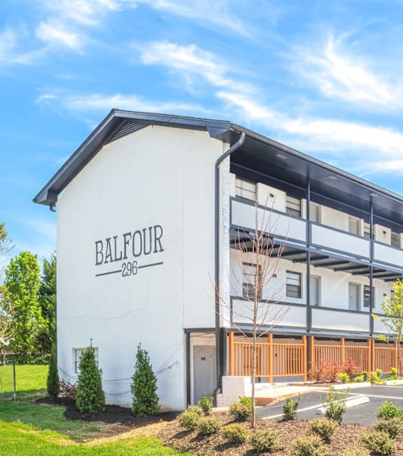 A white building with the name Balfour on it at Balfour 296 Apartments in GA, 30047