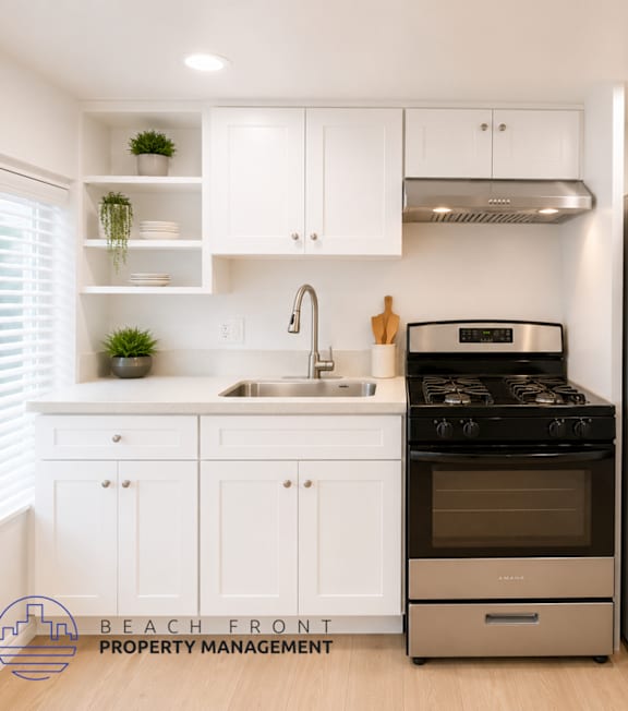 A modern kitchen with a stainless steel refrigerator and stove.