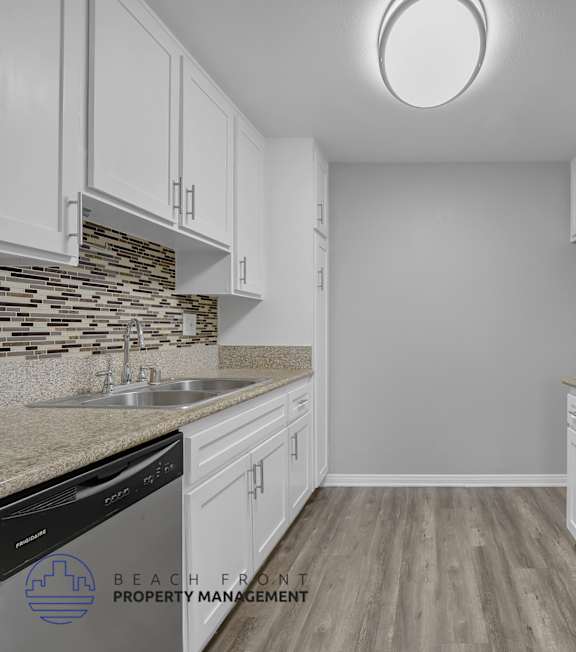 A well-lit, modern kitchen and living room with a dining area.