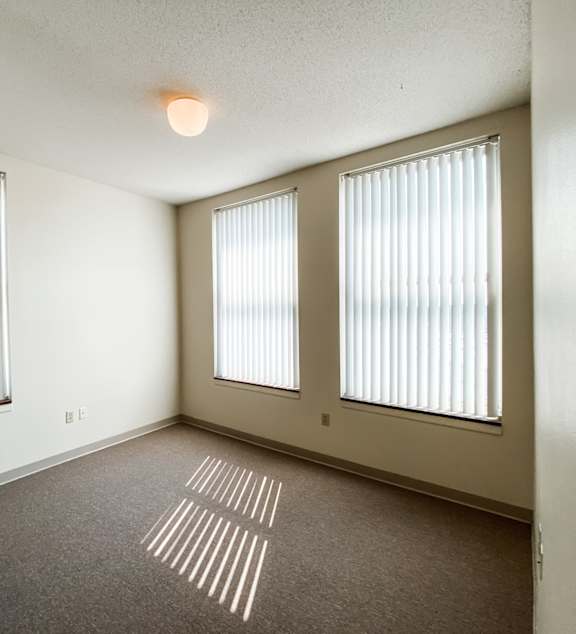 a living room and kitchen with a couch and a table