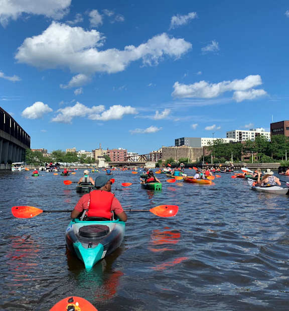 A group of people kayaking on a river.