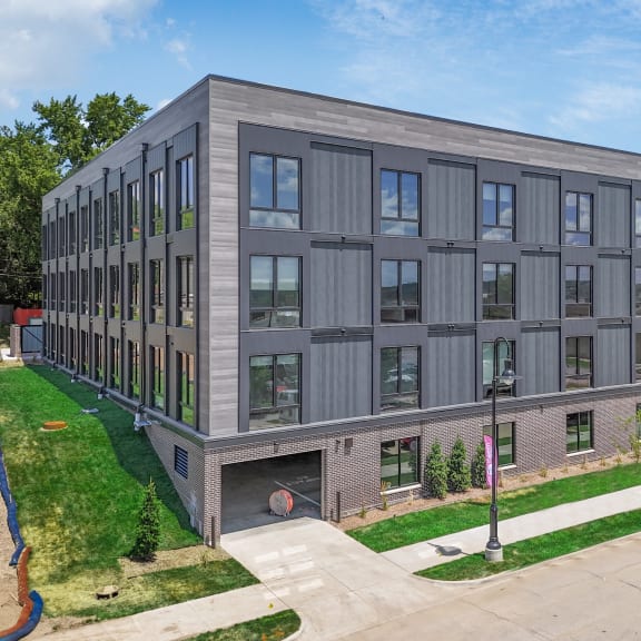 a new apartment building on the corner of a sidewalk