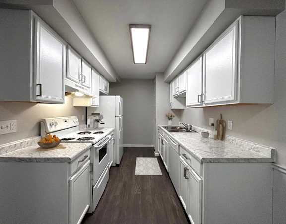 A kitchen with white appliances and cabinets.