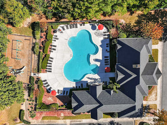 An aerial view of a swimming pool with umbrellas at Alexander Ridge Apartments, Canton, Georgia
