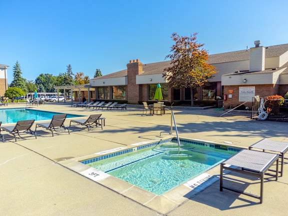 our resort style swimming pool is next to our building with lounge chairs