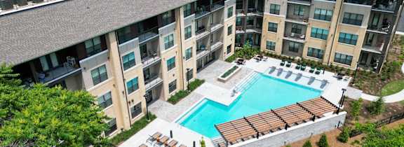 A large apartment complex with a pool and hot tub.