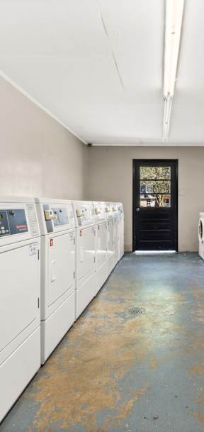 A row of washing machines in a laundromat.