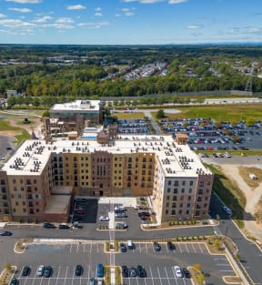 an aerial view of a building in a parking lot