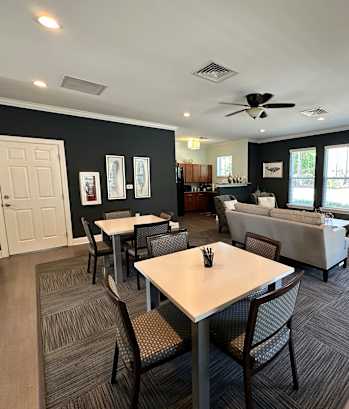 a living room with a table and chairs and a couch