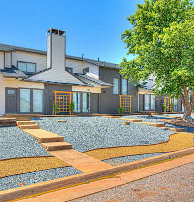 the front of a house with a gravel yard and a tree at Diamond Ridge Townhomes, Oklahoma ,73114