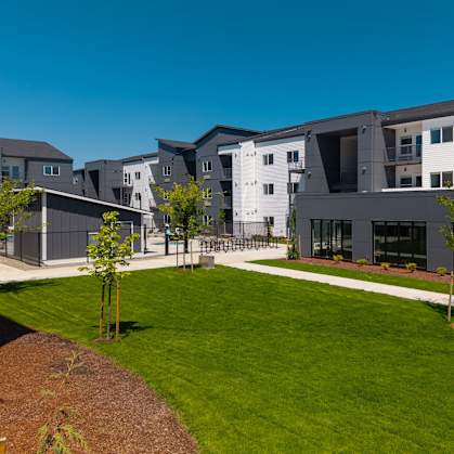 Modern apartment complex with a well-maintained lawn in front at The Arvon, Vancouver, 98662